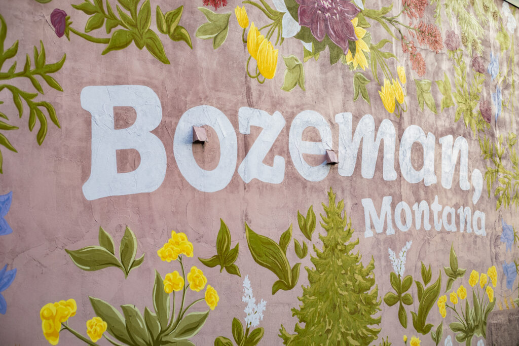 Painted floral mural reading Bozeman, Montana on a downtown wall